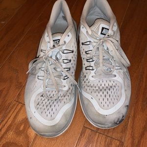 grey nike’s with some paint marks